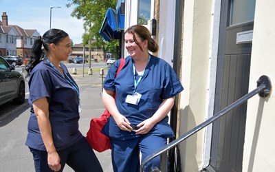 Picture of two nurses talking outside