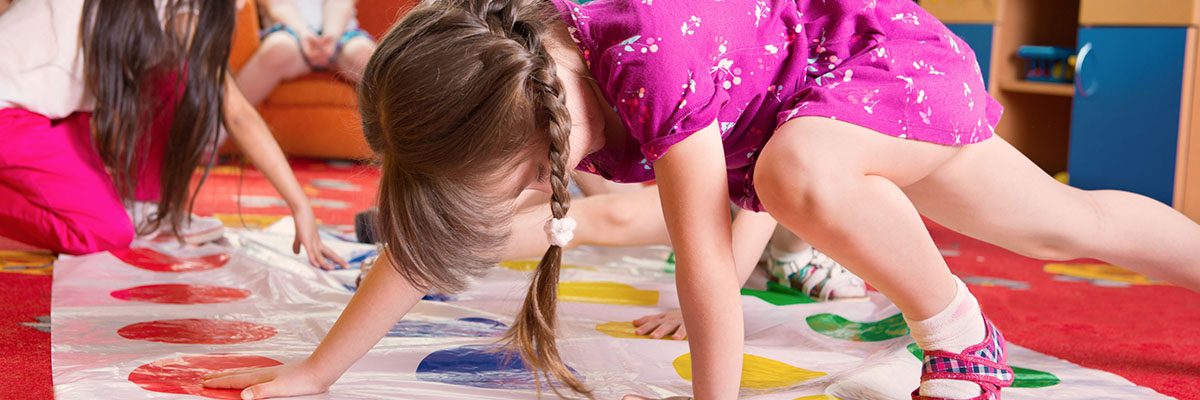 Young girls playing Twister at nursery