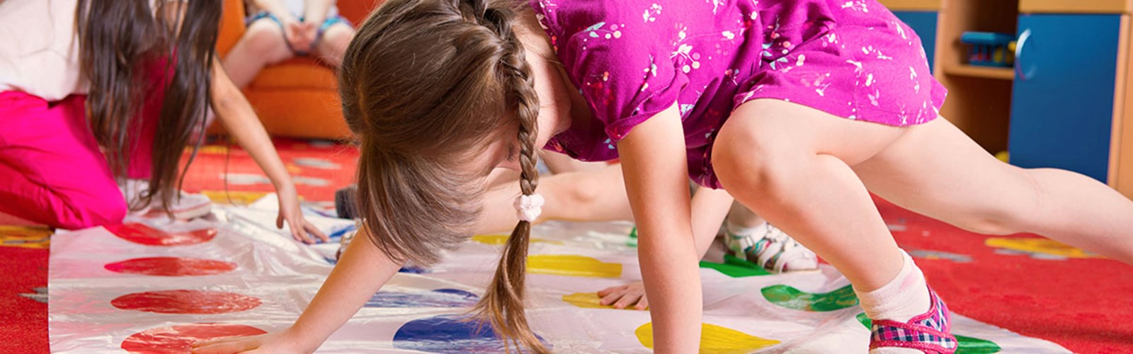 Young girls playing Twister at nursery