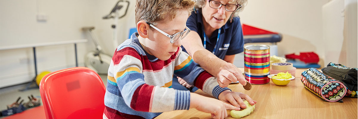 Boy doing an exercise with an occupational therapist