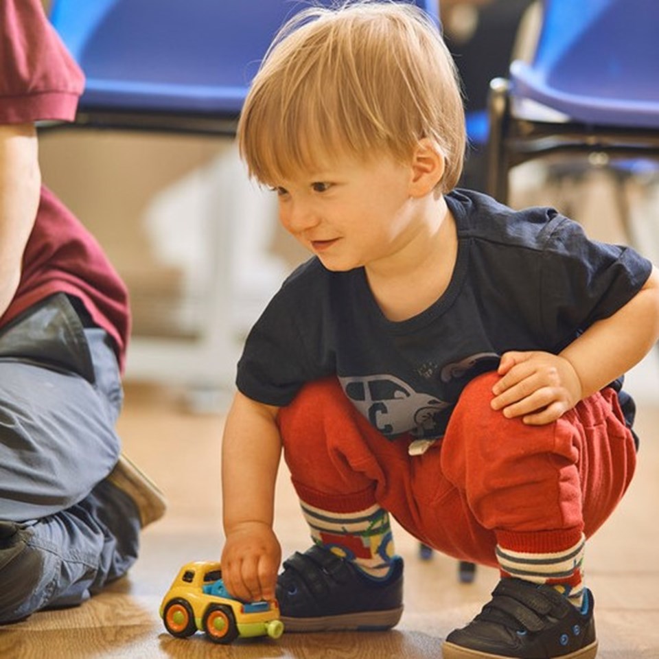 Child playing with car